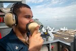 221018-N-ER894-1053 MANILA BAY (Oct. 18, 2022) Operations Specialist 3rd Class Isaac Shelton, from Bandera, Texas, operates a sound-powered telephone while standing watch on vulture’s row aboard the U.S. Navy’s only forward-deployed aircraft carrier, USS Ronald Reagan (CVN 76), in Manila Bay, Philippines, Oct. 18. Ronald Reagan, the flagship of Carrier Strike Group 5, provides a combat-ready force that protects and defends the United States, and supports alliances, partnerships and collective maritime interests in the Indo-Pacific region. (U.S. Navy photo by Mass Communication Specialist Seaman Timothy Dimal)
