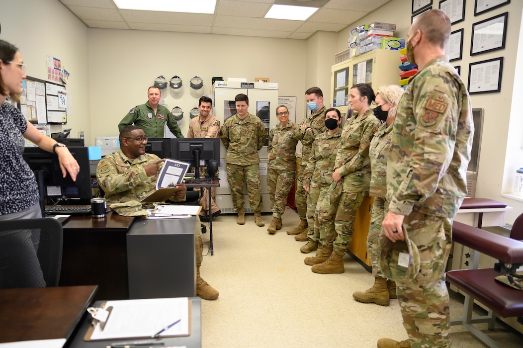 Senior Master Sgt. Ché Kinnard, seated, talks with members of the 188th Medical Group at Ebbing Air National Guard Base, Arkansas. The 188th Medical Group heads to Guatemala in October 2022 for a joint, Medical Ready Training Exercise mission with the Navy.
