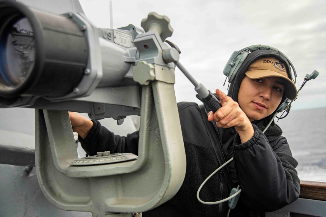 Legalman Seaman Audrey Carillo locates nearby ships with the big eye lens USS Chung-Hoon (DDG 93).