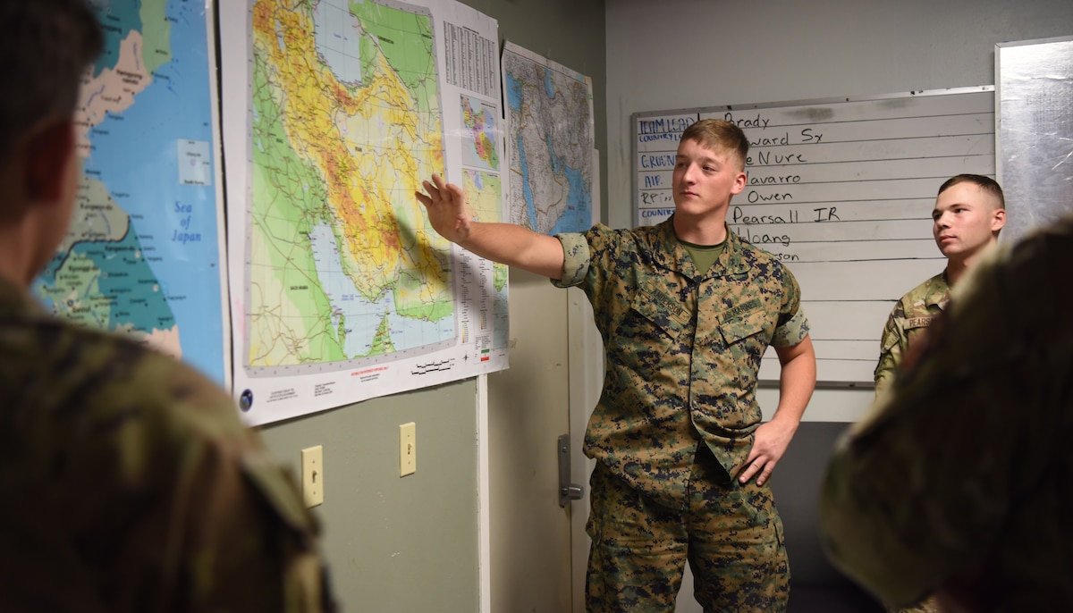 U.S. Marine Corps Lance Cpl. Preston Anderson, Marine Corps Detachment student, briefs during his capstone exercise, Operation Loneshark, at Goodfellow Air Force Base, Texas, Oct. 11, 2022. Anderson briefed the importance of situational awareness for friendly assists. (U.S. Air Force photo by Senior Airman Abbey Rieves)