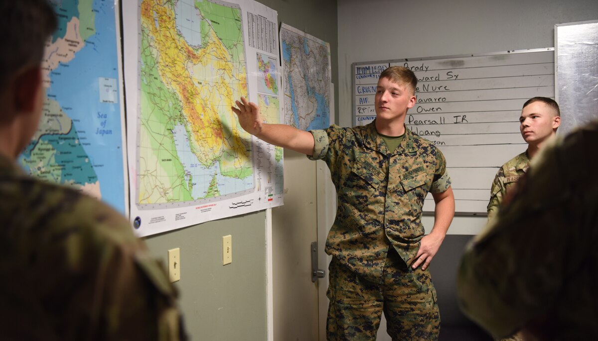 U.S. Marine Corps Lance Cpl. Preston Anderson, Marine Corps Detachment student, briefs during his capstone exercise, Operation Loneshark, at Goodfellow Air Force Base, Texas, Oct. 11, 2022. Anderson briefed the importance of situational awareness for friendly assists. (U.S. Air Force photo by Senior Airman Abbey Rieves)
