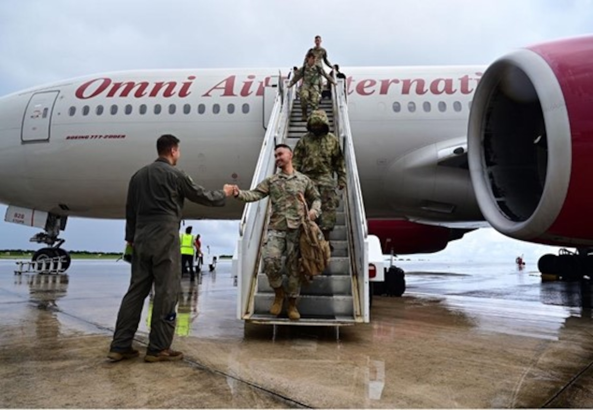 U.S. Air Force Lt. Col. Daniel Mount, 37th Bomb Squadron Director of Operations, greets Airmen from Ellsworth Air Force Base, South Dakota, as they arrive at Andersen AFB, Guam, for a Bomber Task Force Mission, October 16, 2022. Bomber Task Force missions enhance readiness, to include joint and multi-lateral, to respond to any potential crisis or challenge in the Indo-Pacific. (U.S. Air Force photo by Staff Sgt. Hannah Malone)