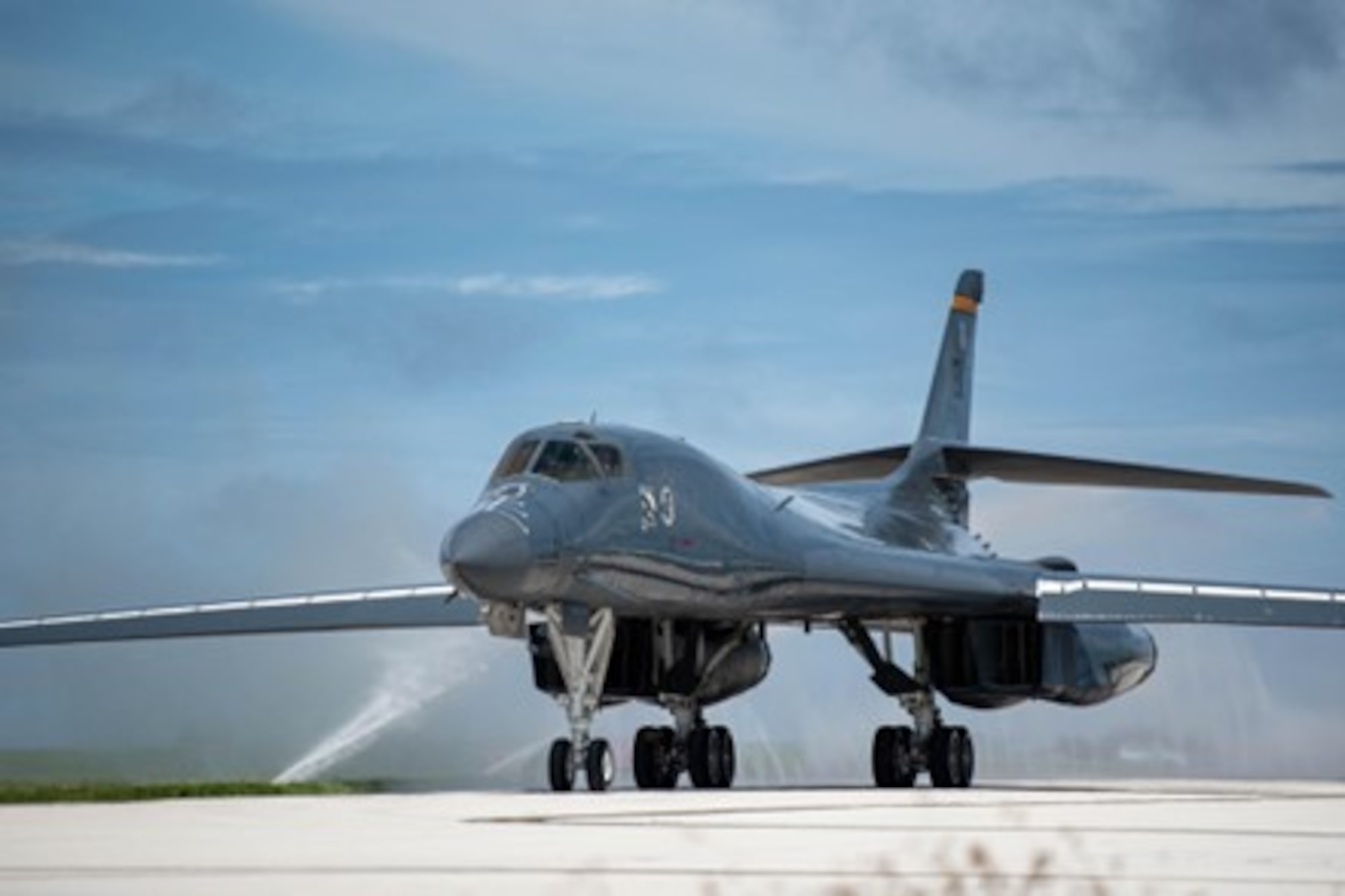 A U.S. Air Force B-1B Lancer assigned to the 37th Expeditionary Bomb Squadron, Ellsworth Air Force Base, South Dakota, taxis through a clean water wash station at Andersen Air Force Base, Guam, Oct. 18, 2022. These missions enhance readiness, to include joint and multi-lateral, to respond to any potential crisis or challenge in the Indo-Pacific. (U.S. Air Force photo by Senior Airman Yosselin Campos)