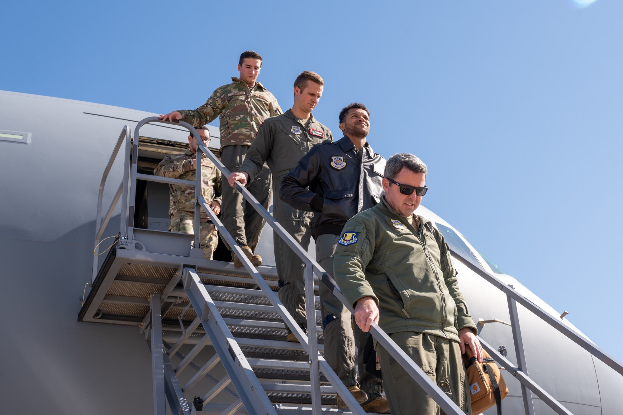 A mixed crew from McConnell Air Force Base, Kansas, and Joint Base McGuire-Dix-Lakehurst, N.J., exit a KC-46A Pegasus after flying a training mission Oct. 19, 2022, at McConnell AFB.