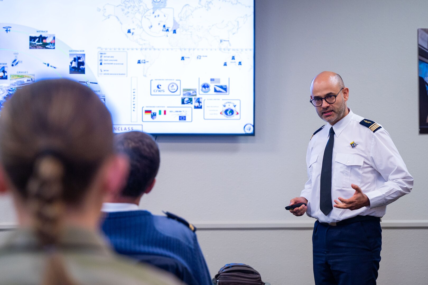 A French space operator from the Operational Center for Military Surveillance of Space Objects (COSMOS) instructs about the COSMOS organization structure and mission set during an Operator Exchange event hosted by the 18th Space Defense Squadron (18 SDS) at Vandenberg Space Force Base, Calif., Oct. 5, 2022. The 4-day event aimed to advance global space domain awareness between the two groups by exchanging common practices, spotlighting mission capabilities, and explaining methodologies of their respective programs. (U.S. Space Force photo by Tech. Sgt. Luke Kitterman)