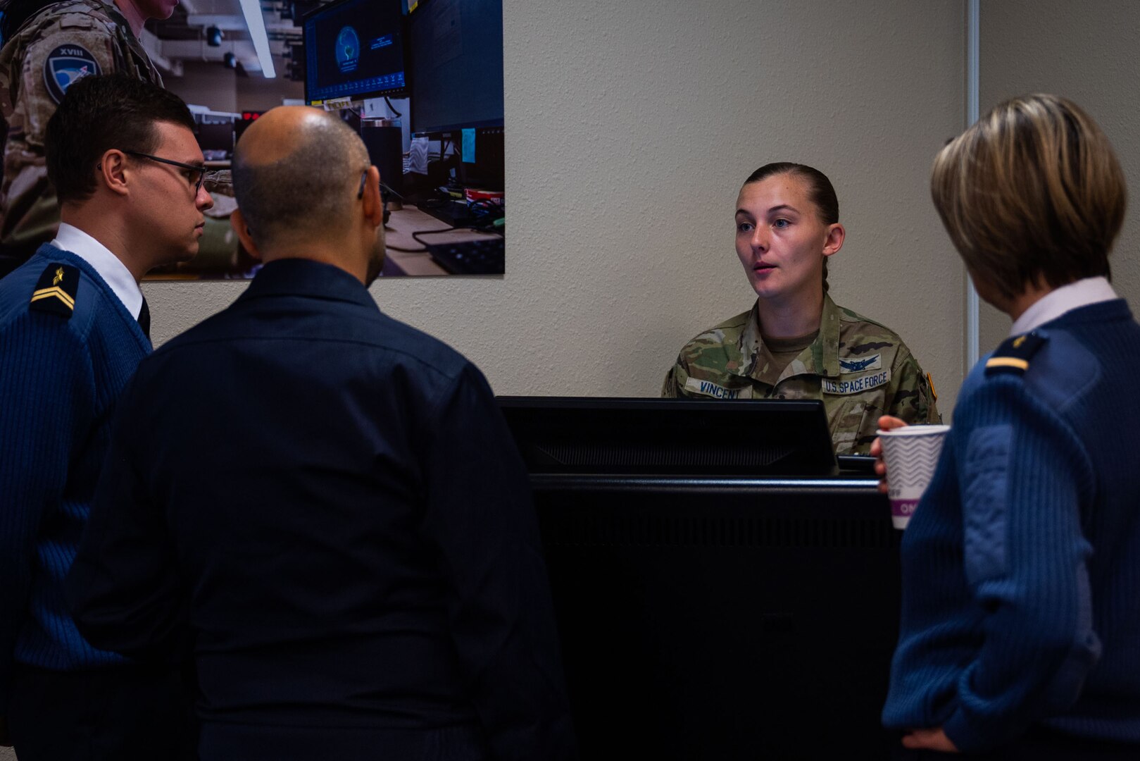 U.S. Space Force Sgt. Brianna Vincent, 18th Space Defense Squadron (18 SDS) Space Situational Awareness (SSA) coordinator and lead planner for the COSMOS exchange, speaks with French space operators from the Operational Center for Military Surveillance of Space Objects (COSMOS) during an Operator Exchange event at Vandenberg Space Force Base, Calif., Oct. 4, 2022. The 4-day event aimed to advance global space domain awareness between the two groups by exchanging common practices, spotlighting mission capabilities, and explaining methodologies of their respective programs. (U.S. Space Force photo by Tech. Sgt. Luke Kitterman)