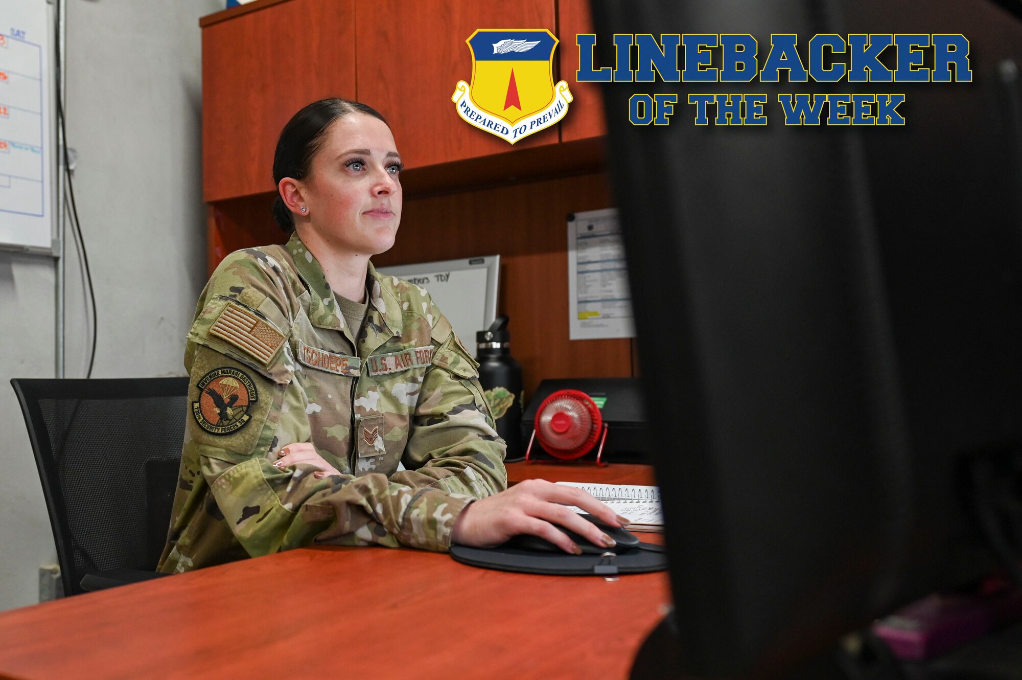 An Airman working behind a computer.
