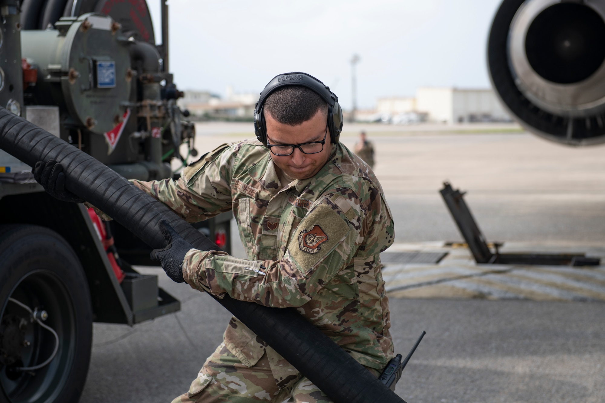 U.S. Air Force Staff Sgt. Elisamuel Saezvazquez, 18th Logistics Readiness Squadron fuels service center supervisor, pulls an R-12 refueling truck hose at Kadena Air Base, Japan, Oct. 13, 2022. Airmen from the 18th Wing conducted the first hot-pit refueling of a KC-46A Pegasus at Kadena while also gaining familiarization with the aircraft, increasing Kadena’s ability to support the Indo-Pacific region. (U.S. Air Force photo by Senior Airman Jessi Roth)