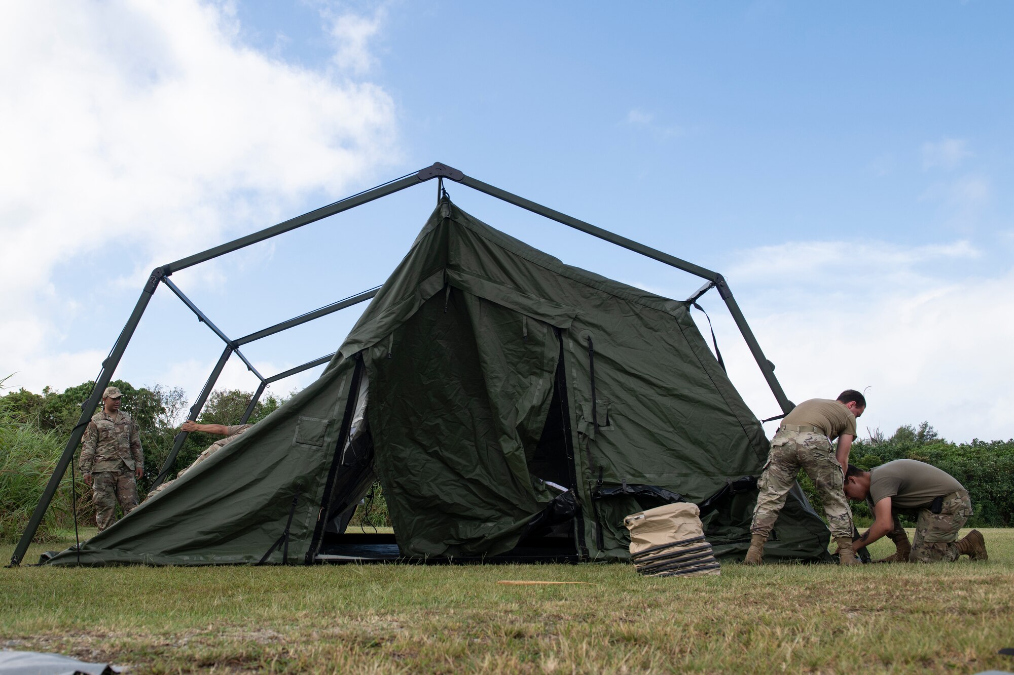 U.S. Air Force Airmen assigned to the 18th Wing set up a tent during an Agile Combat Employment exercise at Okuma Beach, Japan, Oct. 14, 2022. The ACE concept is centered around minimizing the reliance on prepared airfields by enabling the dispersal of smaller units to various locations while still meeting operational needs. (U.S. Air Force photo by Senior Airman Jessi Roth)