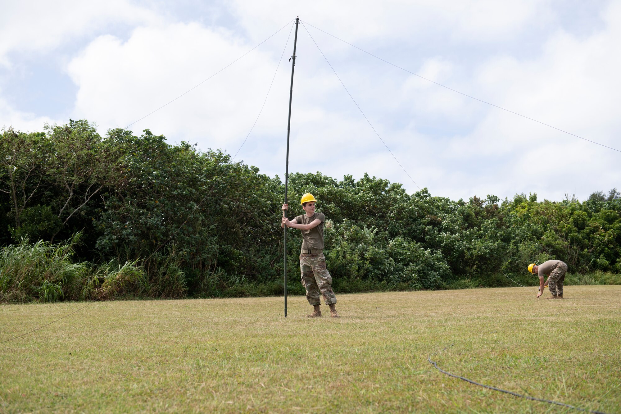 U.S. Air Force Airmen assigned to the 353rd Special Operations Support Squadron secure a high frequency radio antenna during an Agile Combat Employment exercise at Okuma Beach, Japan, Oct. 14, 2022. The ACE concept of operations provides flexibility by enabling U.S. forces to operate more resiliently and effectively in contested or degraded environments.  (U.S. Air Force photo by Senior Airman Jessi Roth)