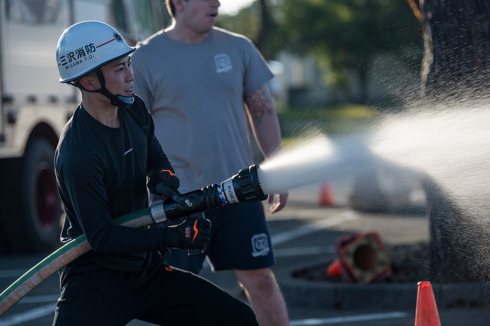 Competitor sprays a fire hose during the annual Fire Muster.