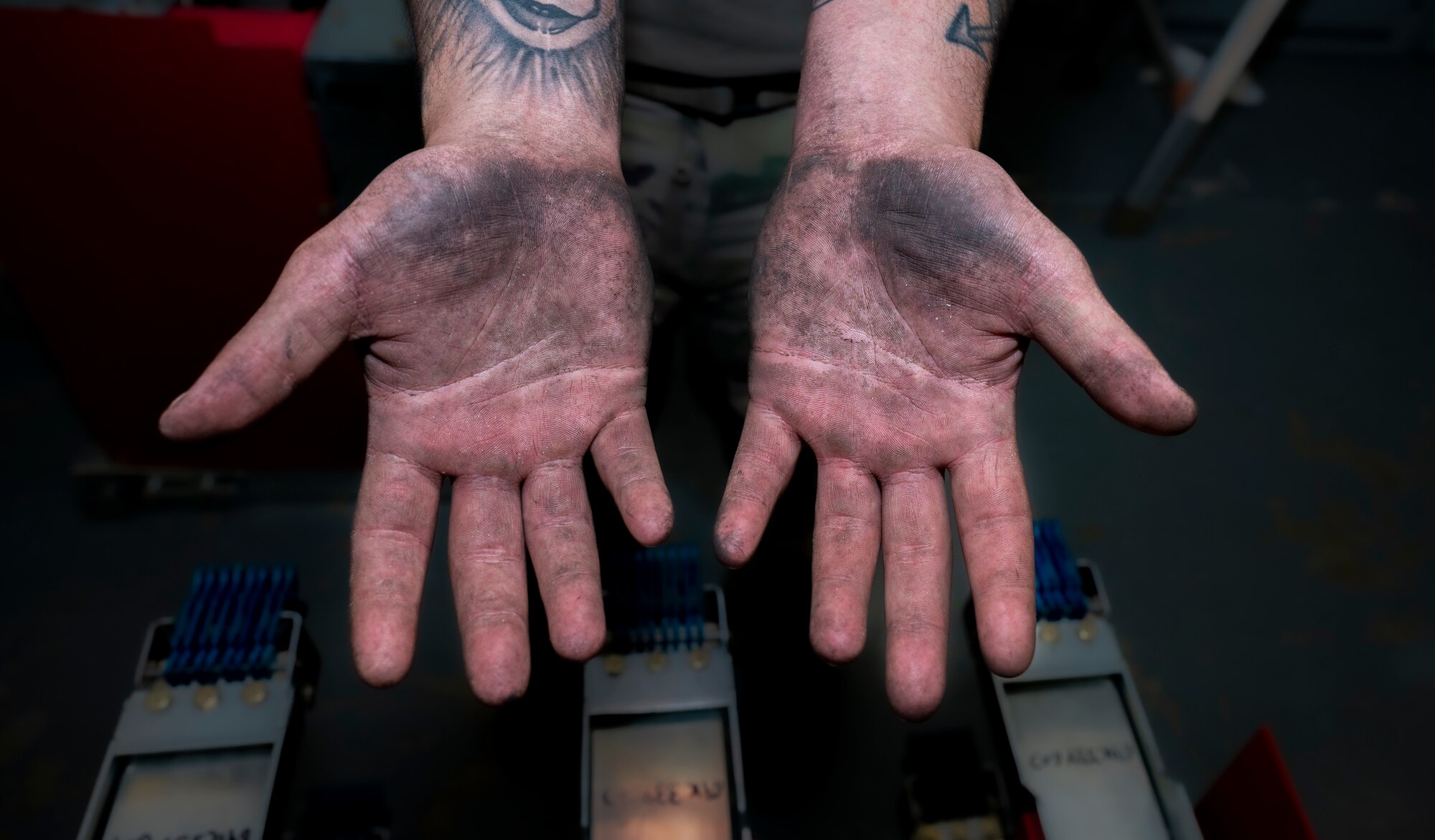 U.S. Air Force Staff Sgt. Brenden Kerwin, 51st Civil Engineering Squadron electrical systems journeyman displays his hands after performing maintenance to a switchgear and high-voltage circuit breakers in a substation at Osan Air Base, Republic of Korea, Oct. 10, 2022.