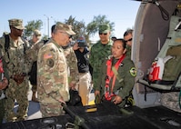 Mexican army Subteniente (2nd Lieutenant) Leticia Rodriguez Garcia, an aerospace medical nurse with Military Hospital San Miguel (Mexico State), explains the casualty evacuation capabilities of an UH-60M Blackhawk helicopter to Joint Task Force Civil Support commanding general, U.S. Army Maj. Gen. Jeffrey Van and Mexican army General De Brigada (Maj. Gen.) Roberto Claudio del Rosal Ibarra, the 8th Military Zone commander, during exercise Fuerzas Amigas 2022 at Campo Militar Reynosa, Mexico, Oct. 19, 2022.