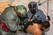 U.S. Soldiers assigned to the 526th Engineer Company, 92nd Engineer Battalion, 20th Engineer Brigade, from Fort Stewart, Ga., and Mexican army soldiers assigned to the 19th Motorized Cavalry Regiment decontaminate a simulated casualty after pulling them from an area with chemical, biological, radiological or nuclear contamination during exercise Fuerzas Amigas 2022 at Campo Militar Reynosa, Mexico, Oct. 19, 2022.