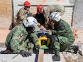 U.S. Soldiers assigned to the 526th Engineer Company, 92nd Engineer Battalion, 20th Engineer Brigade, from Fort Stewart, Ga., and Mexican army soldiers assigned to the 19th Motorized Cavalry Regiment rescue a simulated casualty while conducting search-and- rescue training during exercise Fuerzas Amigas 2022 at Campo Militar Reynosa, Mexico, Oct. 19, 2022.