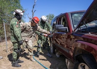 U.S. Soldiers assigned to the 526th Engineer Company, 92nd Engineer Battalion, 20th Engineer Brigade, from Fort Stewart, Ga., and Mexican army soldiers assigned to the 19th Motorized Cavalry Regiment extract a simulated casualty from a vehicle using the Jaws of Life during search-and-rescue training as part of exercise Fuerzas Amigas 2022 at Campo Militar Reynosa, Mexico, Oct. 19, 2022.
