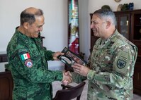 Joint Task Force Civil Support commanding general, U.S. Army Maj. Gen. Jeffrey Van presents a gift to Mexican army General De Brigada (Maj. Gen.) Roberto Claudio del Rosal Ibarra, the 8th Military Zone commander, during exercise Fuerzas Amigas 2022 at Campo Militar Reynosa, Mexico, Oct. 19, 2022.