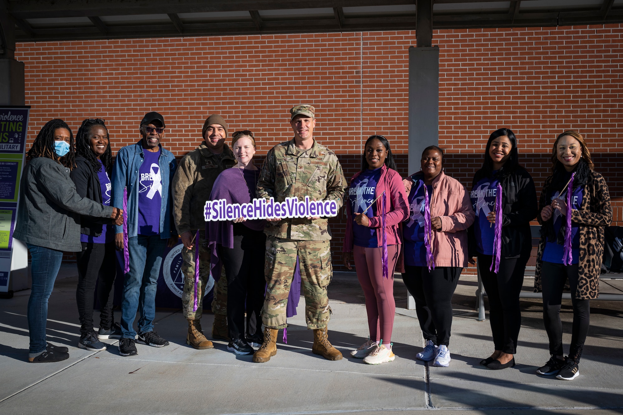 Col. Lucas Teel, center, 4th Fighter Wing Commander, poses for a photo with members of 4th FW during Domestic Violence Awareness Month at Seymour Johnson Air Force Base, North Carolina, Oct. 20, 2022. DVAM was first recognized in 1987 to raise awareness for domestic violence.