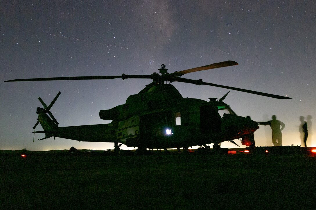 U.S. Marines assigned to Marine Aviation Weapons and Tactics Squadron One conduct a post flight check on a UH-1Y Venom during Weapons and Tactics Instructors course 1-23 near Yuma, Arizona, on Oct. 13, 2022. WTI is a seven-week training event hosted by MAWTS-1, providing standardized advanced tactical training and certification of unit instructor qualifications to support Marine aviation training and readiness, and assists in developing and employing aviation weapons and tactics.