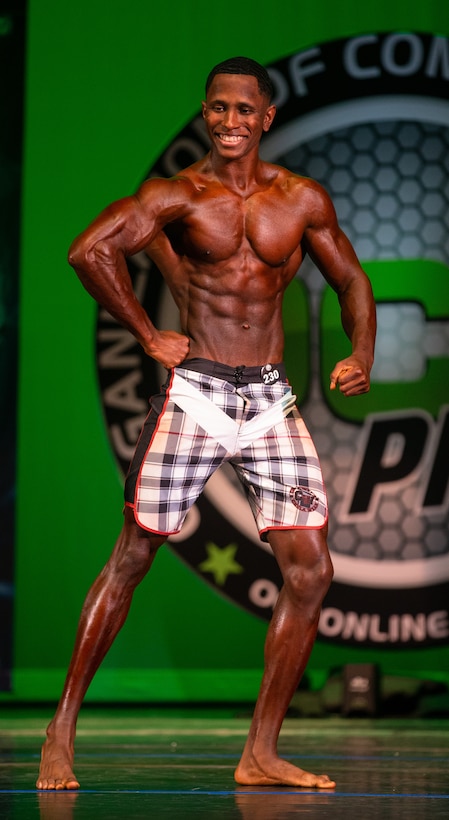 U.S. Marine Corps Sgt. David Hamptonfurr, administrative specialist, Marine Corps Base Quantico, poses for the judges at the 2022 Organization of Competitive Bodybuilding in Bowie, Maryland, Aug. 13, 2022. Hamptonfurr received his professional card Nov. 12, 2021, giving him access to make his professional debut. (U.S. Marine Corps photo by Cpl. Eric Huynh)