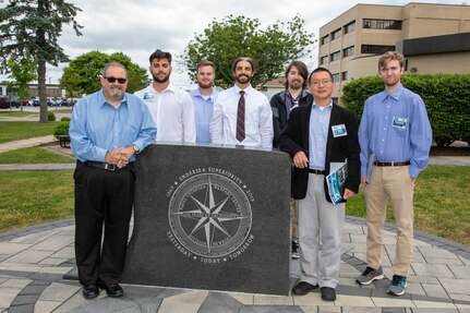 Naval Surface Warfare Center, Philadelphia Division and Rowan University present collaborative research on the development of di-electric materials for cryogenic applications to the Naval Engineering Education Consortium (NEEC) during NEEC Day 2022 at the Naval Undersea Warfare Center Division in Newport, R.I. on June 15, 2022. Pictured: Steve Mastro, deputy chief technology officer (CTO), NSWCPD; Aaron Haines, Jacob Mahon, Nicholas Mahon from Rowan University; Mark Stitch from Temple University; Professor Wei Xue from Rowan University; and Andrew Smith from Penn State University. (U.S. Navy Photo by David Stoehr/Released)