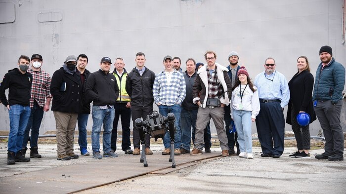 Patrick Violante (centered in photo), team lead for Naval Surface Warfare Center, Philadelphia Division Advanced Data Acquisition Prototyping Technology Virtual Environments (ADAPT.VE) and his team of engineers and scientists are testing both Boston Dynamics and Ghost Robotics Robot Dogs to explore cutting-edge technology and enhance capabilities. These robot dogs are four-legged droids. Designed to minimize human exposure to danger, the semi-autonomous robot dog features a state-of-the art sensor package for both security, surveillance and 3D image capture from its multiple cameras. The concept will demonstrate value of 3D scanning for battle damage assessment and repair and assess the ability for the dogs to be used in theatre to fill critical roles. (U.S. Navy Photo by Samira Gibson/Released)