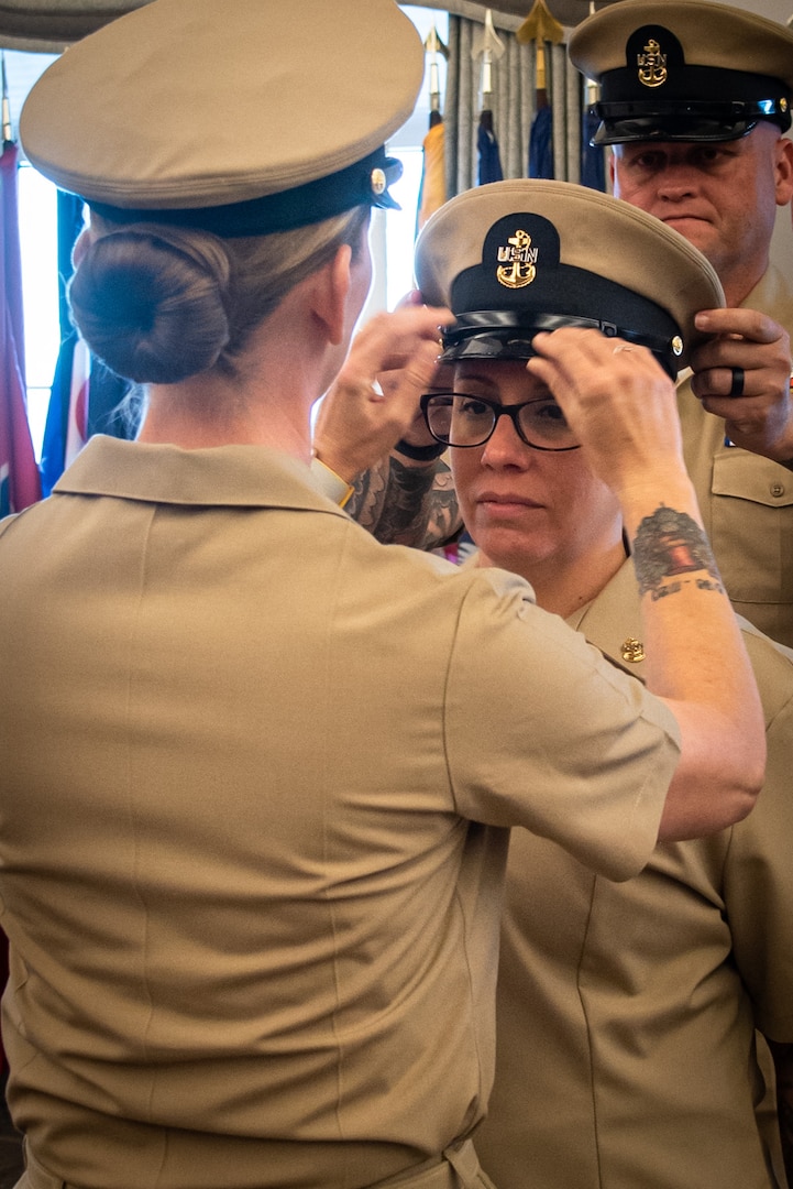 Chief Petty Officer Maggie Adams receives the Chief Petty Officer Khaki Combination Cap during her promotion ceremony Friday, October 21, 2022, aboard Marine Corps Air Station Cherry Point.  Adams and four other sailors advanced to the rank of “Chief” during the ceremony.