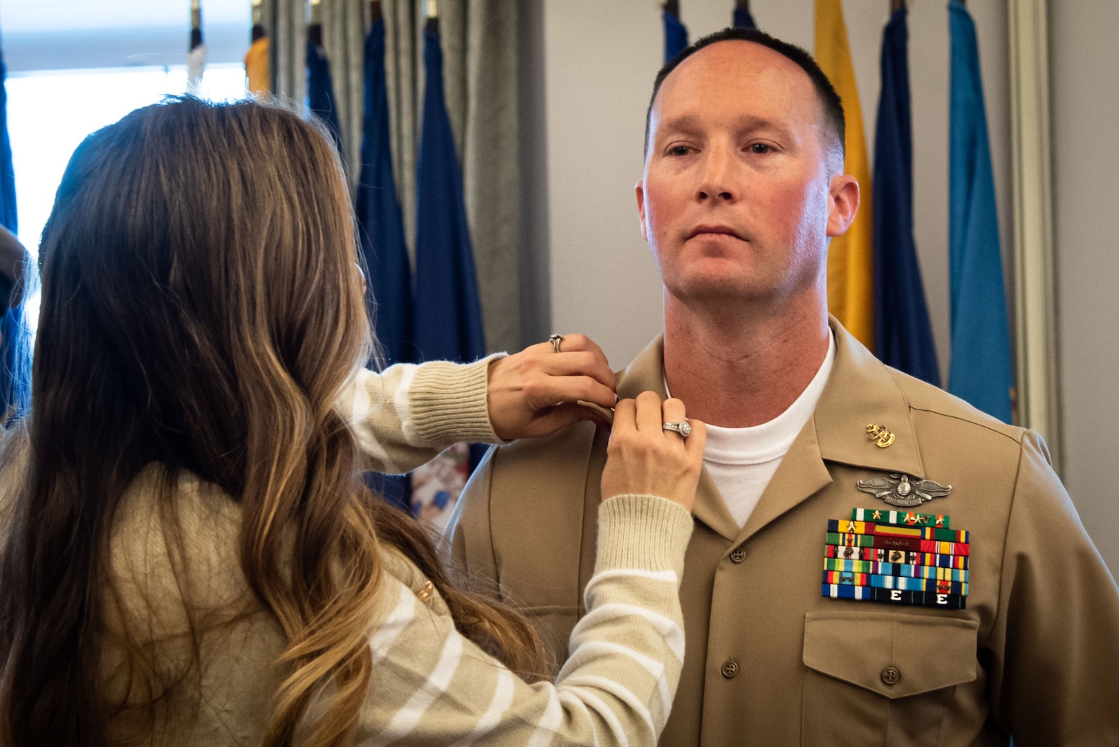 Chief petty Officer Shaun Gafford receives his new rank from his wife during his promotion ceremony.  Gafford and four other sailors advanced to the rank of “Chief” during the ceremony held Friday, October 21, 2022, aboard Marine Corps Air Station Cherry Point.