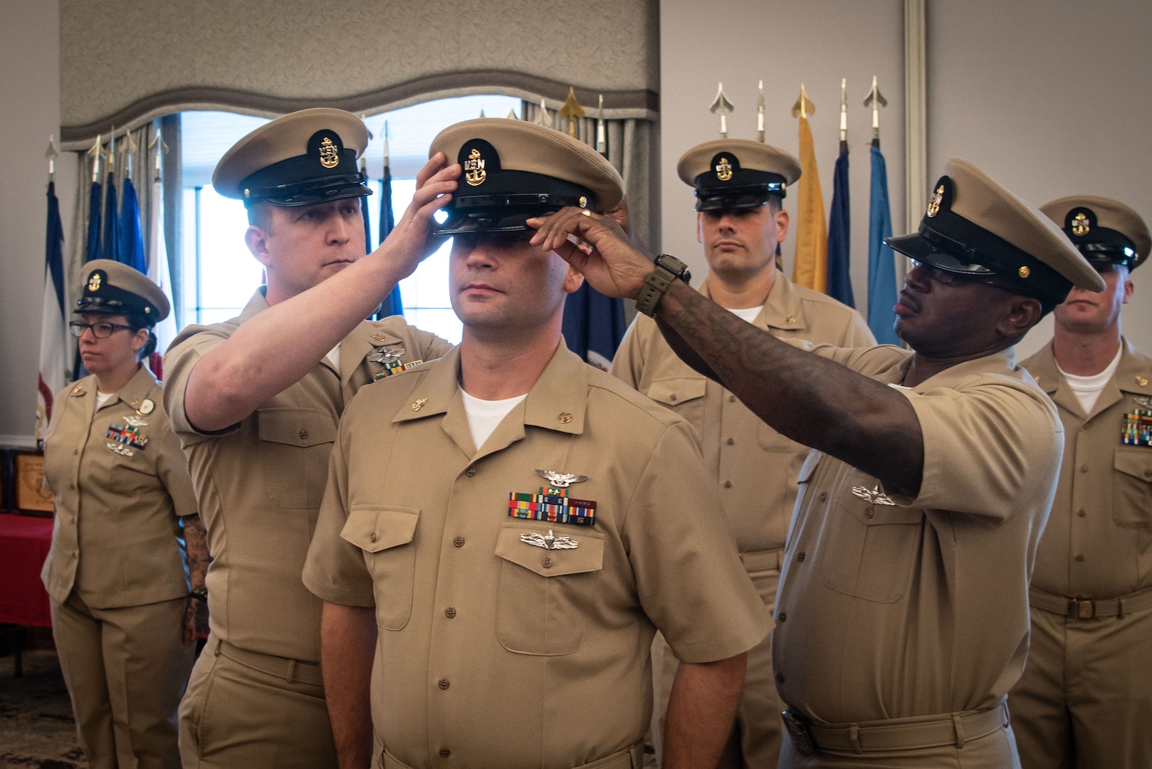 Chief Petty Officer Artan Maloku receives the Chief Petty Officer Khaki Combination Cap during her promotion ceremony Friday, October 21, 2022, aboard Marine Corps Air Station Cherry Point.  Maloku and four other sailors advanced to the rank of “Chief” during the ceremony.