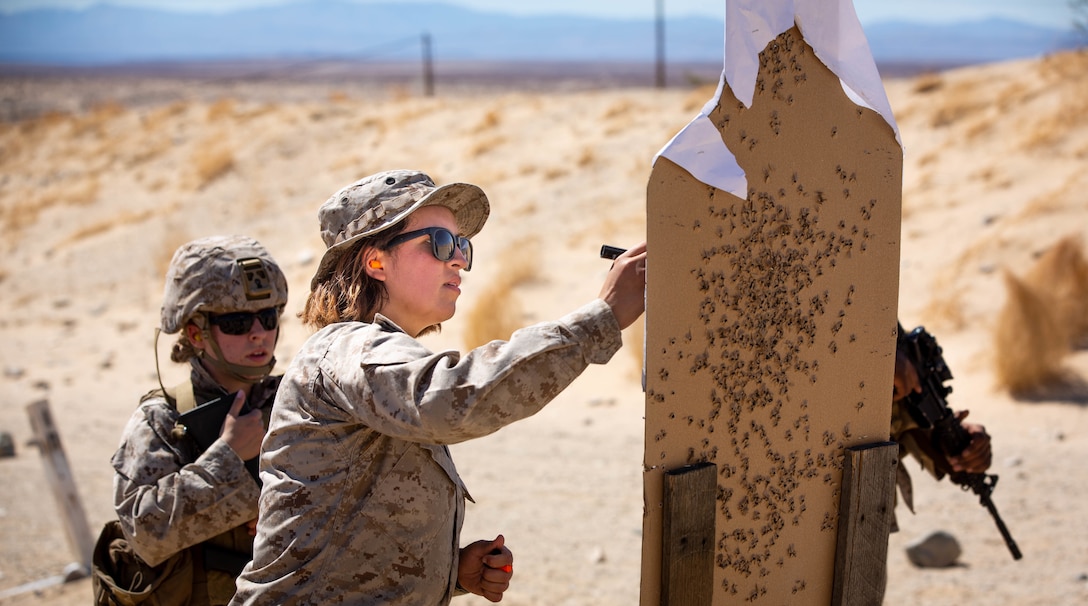 U.S. Marine Corps Lance Cpl. Maribel Rodriguezcarrillo, a motor vehicle operator with Combat Logistics Battalion 1, Combat Logistics Regiment 1, 1st Marine Logistics Group, marks impact grouping on a target point during a Combat Marksmanship Program for Integrated Training Exercise 3-22 on Marine Corps Air Ground Combat Center Twentynine Palms, California, March 30, 2022. ITX is a live-fire event that increases unit readiness.  It teaches the tactical application of combined-arms maneuver, offensive and defensive operations during combat. (U.S. Marine Corps photo by Cpl. Kevin N. Seidensticker)