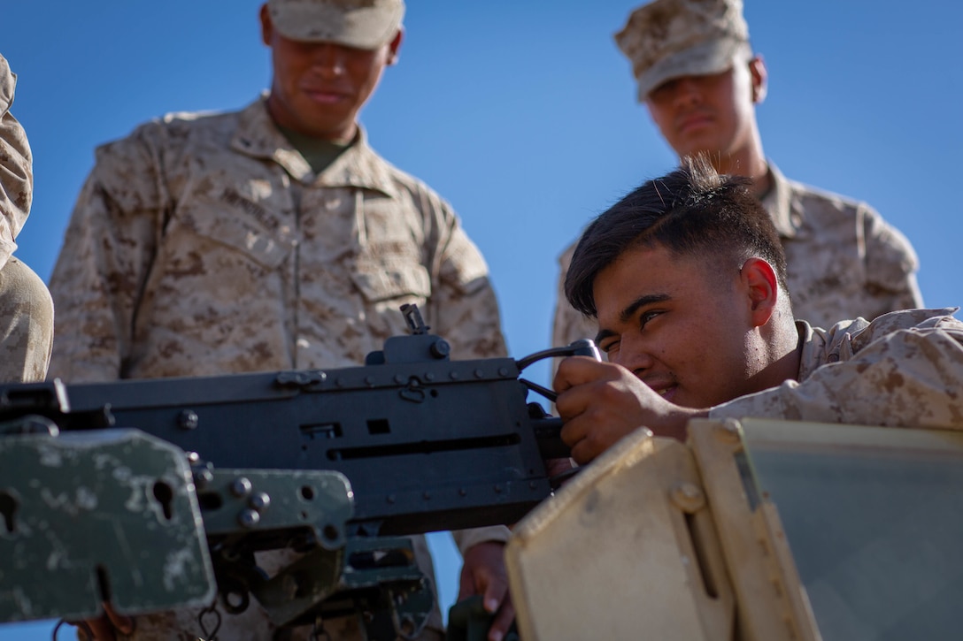 U.S. Marine Corps Lance Cpl. Mario Sainz, a motor transportation operator with Combat Logistics Battalion 1, Combat Logistics Regiment 1, 1st Marine Expeditionary Force, checks the alignment of the barrel to a .50 Caliber Machine Gun during Integrated Training Exercise 3-22 on Marine Corps Air Ground Combat Center Twentynine Palms, California April 1, 2022. ITX is a live-fire event that increases unit readiness.  It teaches the tactical application of combined-arms maneuver, offensive and defensive operations during combat. (U.S. Marine Corps photo by Cpl. Kevin N. Seidensticker)