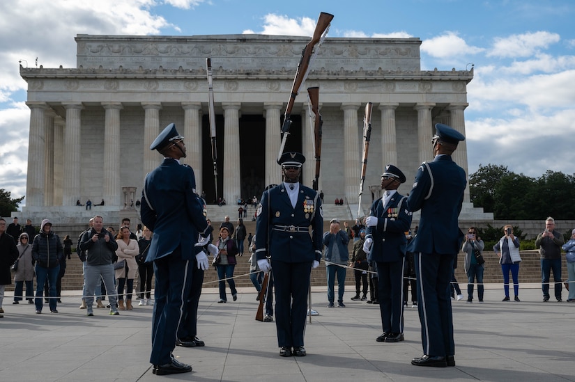 The U.S. Air Force Honor Guard Drill Team competes in a 4-Member Drill during the Joint Services Drill Exhibition at the Lincoln Memorial Plaza, Washington, D.C., Oct. 19, 2022. The Drill Team is an elite unit compromising of 25 Airmen who train, on average, five days a week for eight to ten hours per day to obtain their level of mastery. (U.S. Air Force photo by Kristen Wong)
