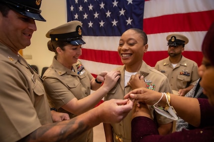 NAVAL STATION NORFOLK (Oct. 21, 2022) Family members and mentors pin Chief Hospital Corpsman Monique Brown’s anchors during the Naval Surface Force Atlantic chief petty officer pinning ceremony onboard Naval Station Norfolk, Oct. 21. Nine Sailors received their gold-fouled anchors during the ceremony. (U.S. Navy photo by Mass Communication Specialist 1st Class Jacob Milham)