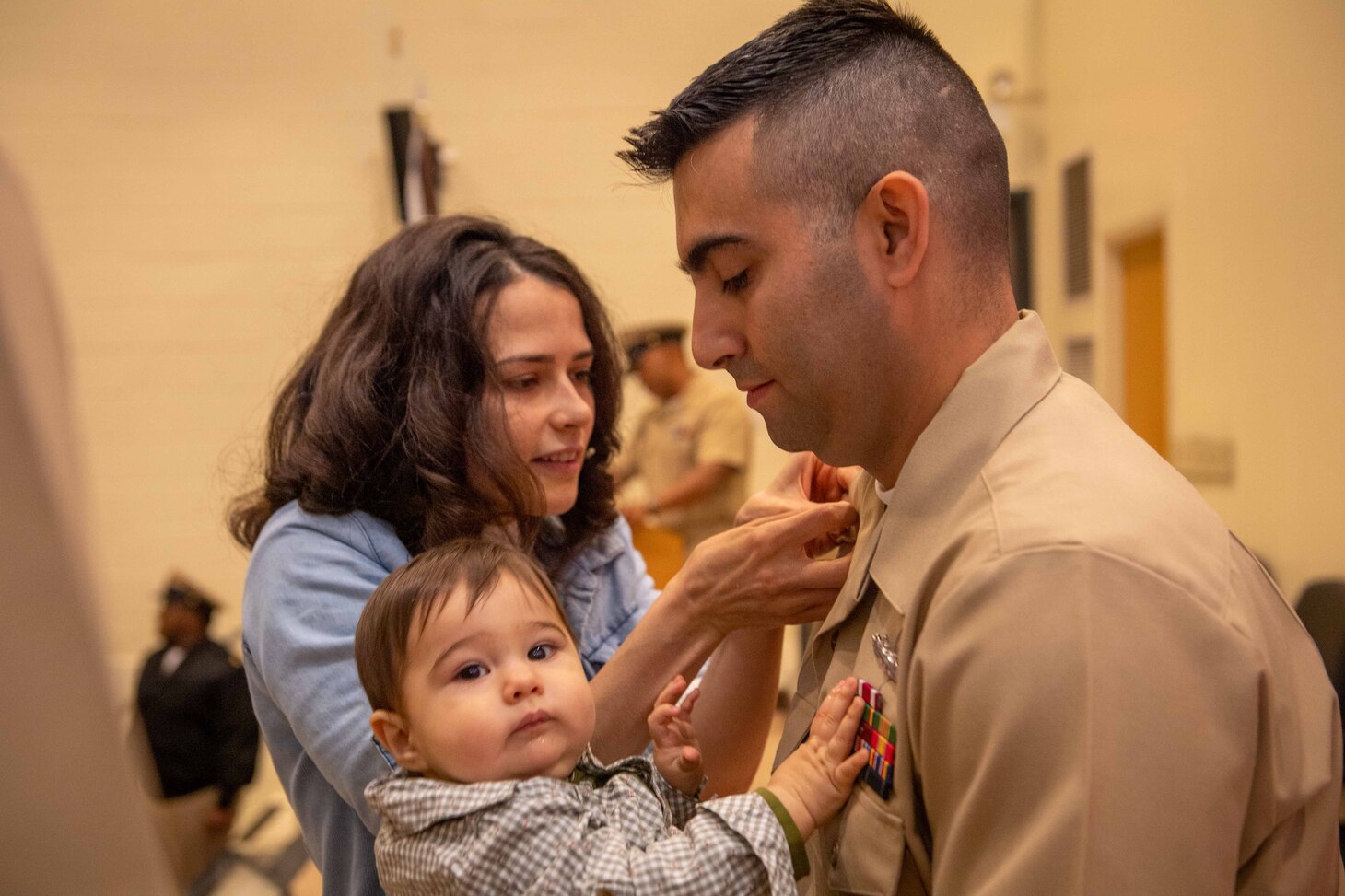 NAVAL STATION NORFOLK (Oct. 21, 2022) Family members pin Chief Electronics Technician Israel Rivera’s anchors during the Naval Surface Force Atlantic chief petty officer pinning ceremony onboard Naval Station Norfolk, Oct. 21. Nine Sailors received their gold-fouled anchors during the ceremony. (U.S. Navy photo by Mass Communication Specialist 1st Class Jacob Milham)