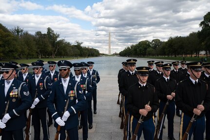 The U.S. Air Force Honor Guard Drill Team and U.S. Army Drill Team await the start of the Joint Services Drill Exhibition at the Lincoln Memorial Plaza, Washington, D.C., Oct. 19, 2022. The event brought together drill teams from the U.S. Air Force, Army, Navy, Marine Corps and Coast Guard to compete for the most superlative display of precision, discipline and teamwork. (U.S. Air Force photo by Kristen Wong)