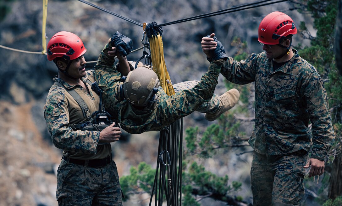 U.S. Marine Corps mountain warfare instructors with Marine Corps Mountain Warfare Training Center (MCMWTC), Marine Air Ground Task Force Training Command, pull a Marine with 2nd Battalion, 1st Marine Regiment, 1st Marine Division, to safety while executing gorge crossing techniques during Mountain  Exercise (MTX) 1-23 at MCMWTC, Bridgeport, California, Sept. 19, 2022. MTX is a month-long exercise designed to prepare  units to survive and operate effectively in austere, mountainous terrain. (U.S. Marine Corps photo by Cpl. Shane T. Beaubien)