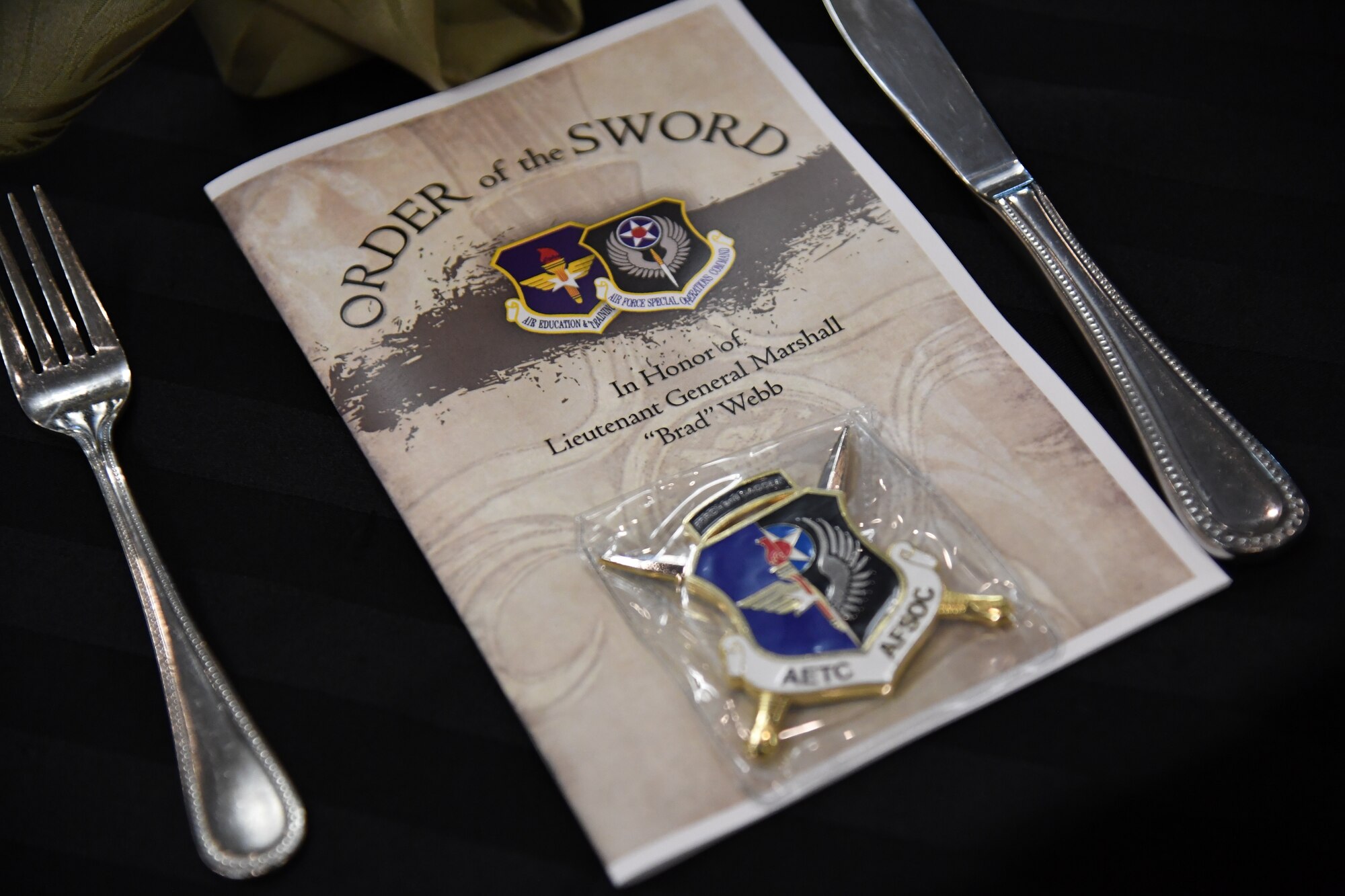 An event program is on display during the Order of the Sword Ceremony at Keesler Air Force Base, Mississippi, Oct. 15,  2022.