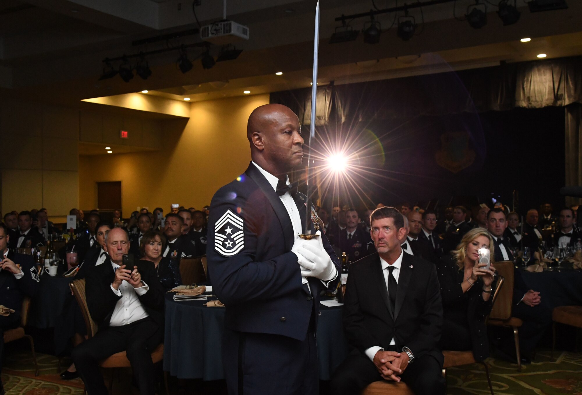 U.S. Air Force Chief Master Sgt. Antonio Cooper, 14th Flying Training Wing command chief, presents a commemorative sword while serving as the Sergeant at Arms during the Order of the Sword Ceremony at Keesler Air Force Base, Mississippi, Oct. 15, 2022