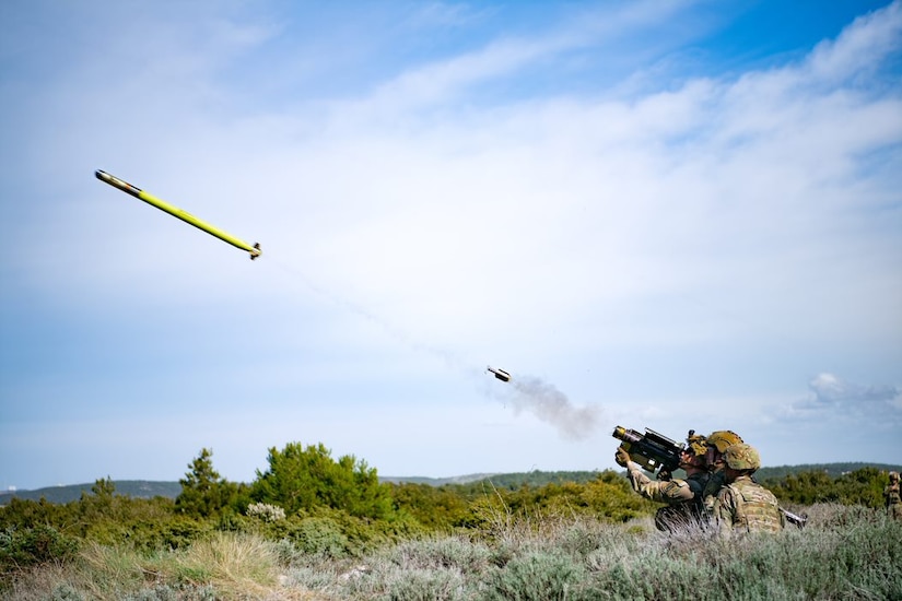 Soldiers fire a missile.