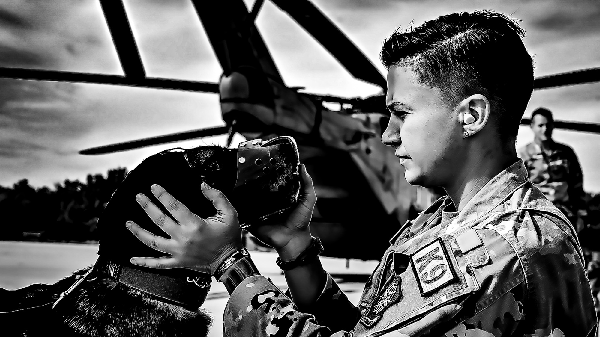 Tech. Sgt. Lindsay Zaccardi, 87th Security Forces Squadron kennel master, and a Military Working Dog assigned to the 87th Security Forces Squadron prepare to fly on a CH-53E assigned to Marine Aircraft Group 49 at Joint Base McGuire-Dix-Lakehurst, N.J. on Oct. 16, 2022. Defenders with 87th SFS K-9 section took part in a joint training with Marines to familiarize the Military Working Dogs with the transportation by helicopter. This skillset was developed for the qualification purposes of bomb detection in deployed environments, where certain terrain may only be accessible by air transportation.