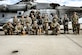 U.S. Air Force Airmen assigned to the 87th Security Forces Squadron and U.S. Marine Corps. Marines assigned to Marine Aircraft Group 49, pose for a photo at Joint Base McGuire-Dix-Lakehurst, N.J. on Oct. 16, 2022. Defenders with 87th SFS K-9 section took part in a joint training with Marines to familiarize the Military Working Dogs with the transportation by helicopter. This skillset was developed for the qualification purposes of bomb detection in deployed environments, where certain terrain may only be accessible by air transportation.