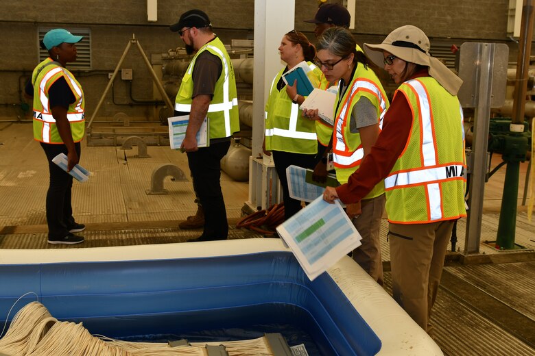 A group of water experts from USACE look at a water filtration membrane.