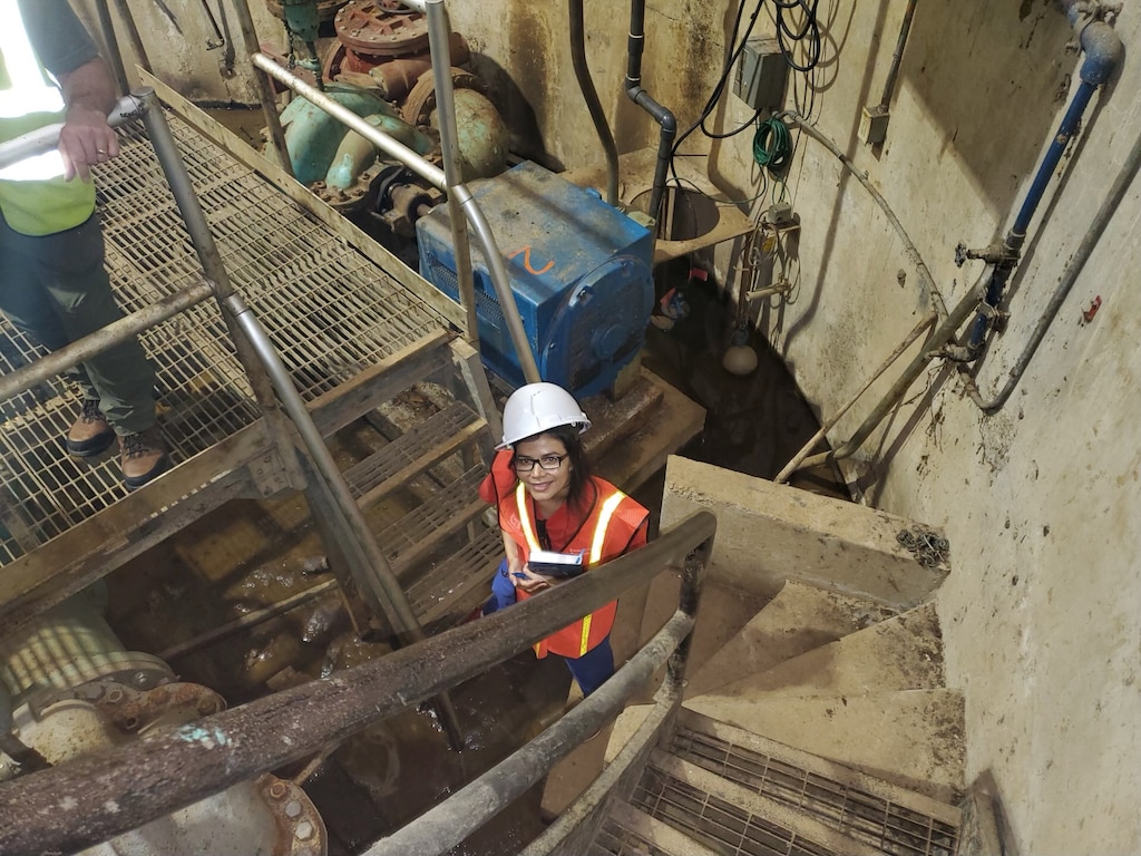 Dr. Martinez-Guerra looks up from the inside of J.H. Fewell Water Treatment Plant