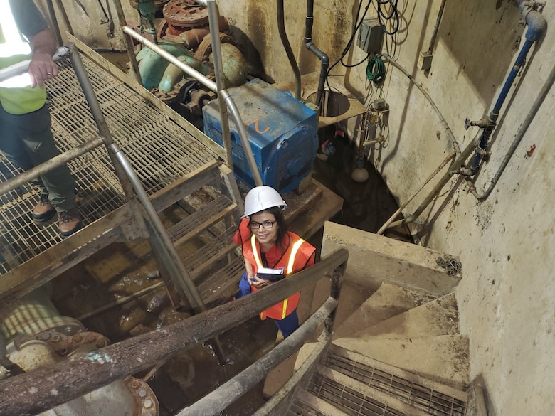 Dr. Martinez-Guerra looks up from the inside of J.H. Fewell Water Treatment Plant