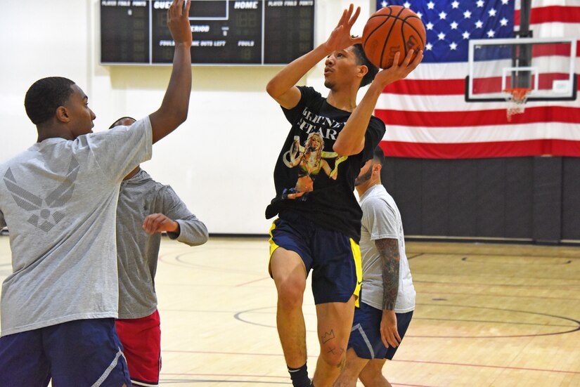 A participant attempts to make a lay-up shot during a game of basketball.