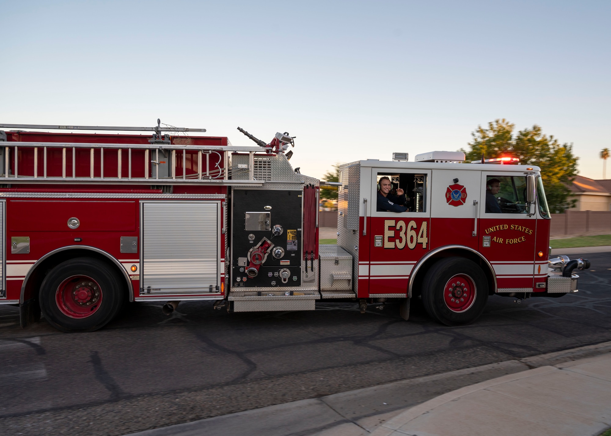 A 56th Civil Engineer Squadron fire truck joins the Fire Prevention Week Parade through base housing Oct. 13, 2022, at Luke Air Force Base, Arizona.