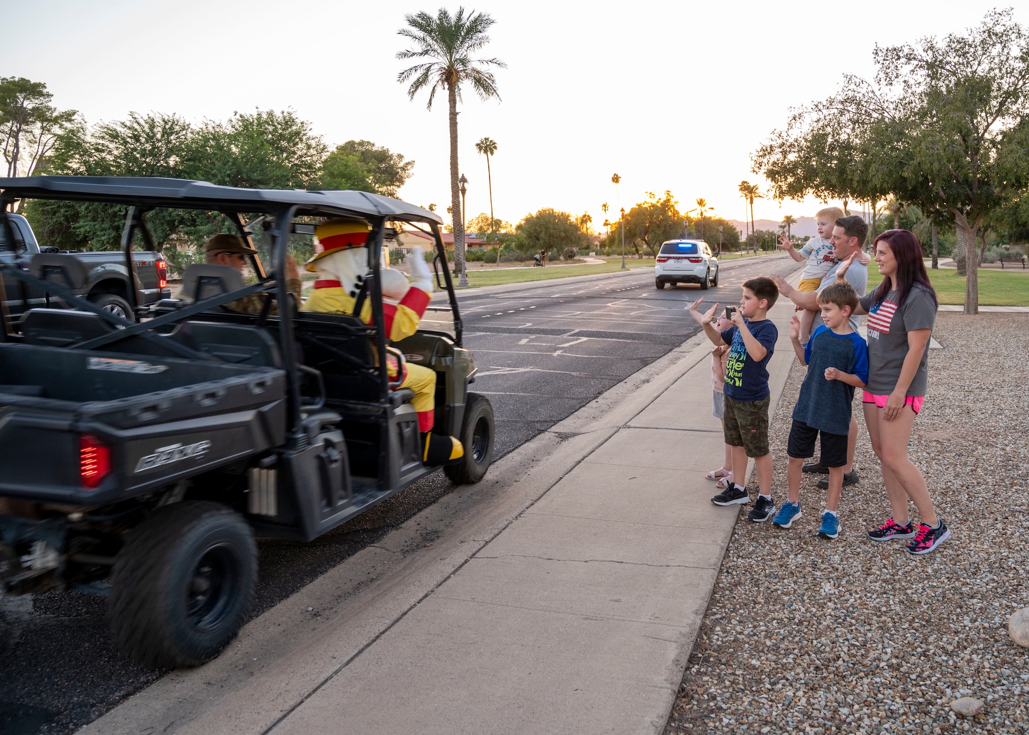 “Sparky”, 56th Civil Engineer Squadron Fire Department mascot, waves hello to a Luke Air Force Base family during the Fire Prevention Week parade Oct. 13, 2022, at Luke Air Force Base, Arizona.