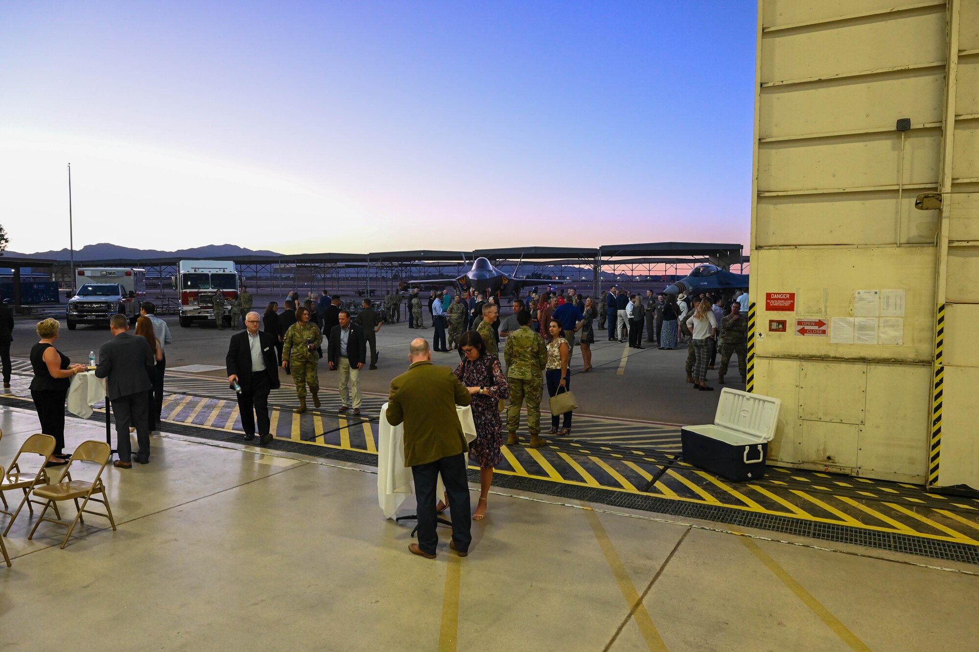 Honorary commander inductees and 56th Fighter Wing Airmen participate in a social hour before an induction ceremony, Oct. 14, 2022, at Luke Air Force Base, Arizona.