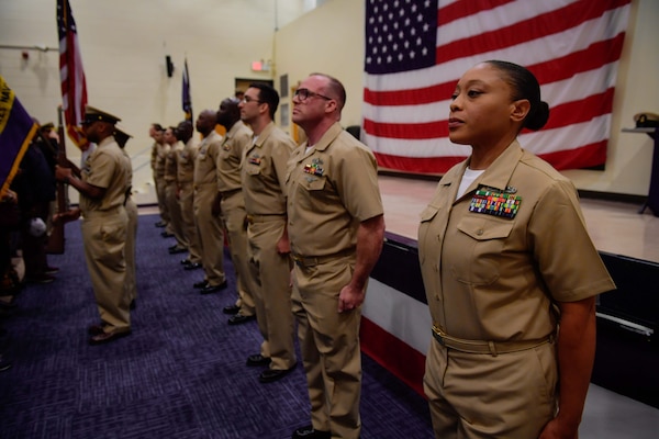 NAVAL STATION NORFOLK (Oct. 21, 2022) Newly promoted chief petty officers stand at attention during the Naval Surface Force Atlantic chief petty officer pinning ceremony onboard Naval Station Norfolk, Oct. 21. Nine Sailors received their gold-fouled anchors during the ceremony. (U.S. Navy photo by Mass Communication Specialist 1st Class Jacob Milham)