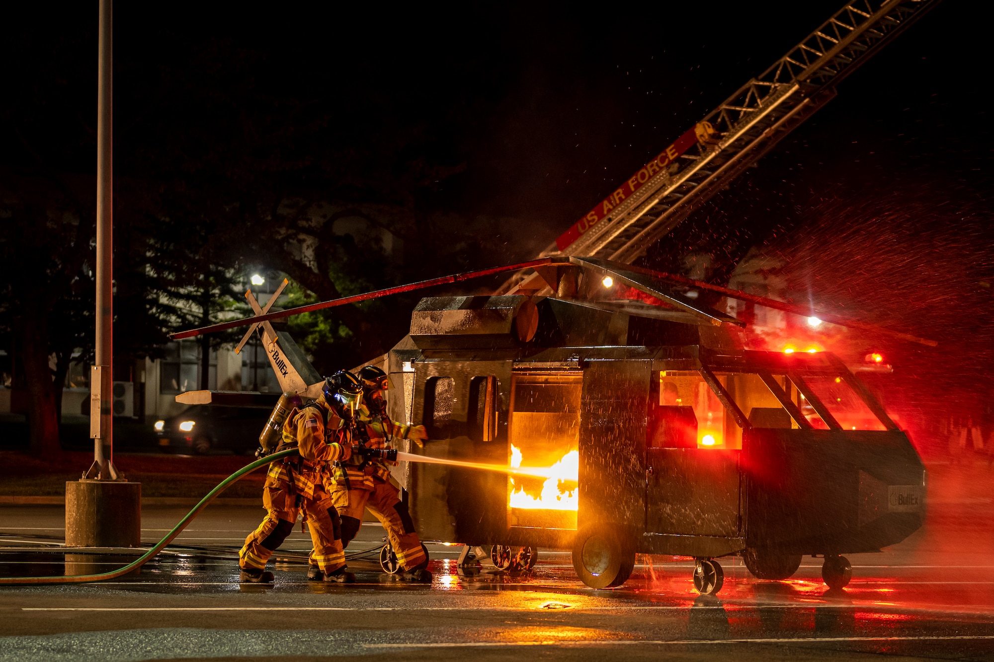 Airmen extinguishing a fire during a live-fire demonstration.